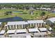 Stunning aerial view of condo community overlooking lush golf course with serene lakes and verdant landscaping at 406 Cerromar N Cir # 128, Venice, FL 34293