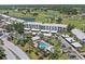 Aerial view of condos near community pool, parking, and a golf course at 406 Cerromar N Cir # 128, Venice, FL 34293