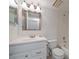 Bathroom with white vanity, framed mirror, and shower-tub combination at 406 Cerromar N Cir # 128, Venice, FL 34293