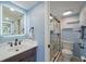 Bright bathroom showcasing a glass enclosed shower, modern fixtures and stylish vanity at 406 Cerromar N Cir # 128, Venice, FL 34293
