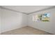 Bright bedroom with tile floors, neutral walls, and large window views at 406 Cerromar N Cir # 128, Venice, FL 34293