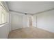 Bright bedroom features neutral tile floors and a double-door closet at 406 Cerromar N Cir # 128, Venice, FL 34293