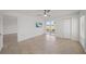 Bright bedroom showcasing tile flooring, a ceiling fan, and access to an outdoor space at 406 Cerromar N Cir # 128, Venice, FL 34293