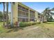 Multi-story condo building with screened balconies and lush landscaping at 406 Cerromar N Cir # 128, Venice, FL 34293