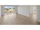 Spacious living area with tile flooring and sliding glass doors that open to a private lanai overlooking the golf course at 406 Cerromar N Cir # 128, Venice, FL 34293