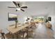 Bright living room with tile flooring, fan, and large windows that provide plenty of natural light and golf course views at 406 Cerromar N Cir # 128, Venice, FL 34293