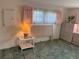 Bedroom with green carpet, pink curtains, and decor in soft, coordinated colors at 411 Cervina N Dr # 493, Venice, FL 34285