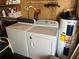 Laundry room features a matching washer and dryer set and a water heater at 411 Cervina N Dr # 493, Venice, FL 34285