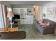 A cozy living room with built-in shelving, comfortable seating, and a sunny window at 411 Cervina N Dr # 493, Venice, FL 34285