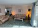 Cozy living room with floral sofas, lamps, and bright, airy ambiance at 411 Cervina N Dr # 493, Venice, FL 34285