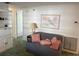 A serene living room showcasing a comfortable gray sofa and decorative wall art at 411 Cervina N Dr # 493, Venice, FL 34285