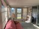 Bright and airy sunroom with a daybed, ample windows, and exterior views at 411 Cervina N Dr # 493, Venice, FL 34285