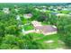 Aerial view of a single-Gathering home with a brick driveway surrounded by trees at 431 Sevilla St, North Port, FL 34287