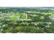 Aerial view of a single-Gathering home with a brick driveway surrounded by trees at 431 Sevilla St, North Port, FL 34287