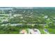 Aerial drone shot of the neighborhood with house nestled among lush greenery at 431 Sevilla St, North Port, FL 34287
