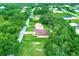 Aerial view of a single-Gathering home with a brick driveway surrounded by trees at 431 Sevilla St, North Port, FL 34287