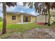 Exterior view of the backyard with an outdoor storage building and covered patio at 431 Sevilla St, North Port, FL 34287