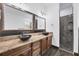 Bathroom featuring double sinks with granite countertops and a shower with decorative tile at 431 Sevilla St, North Port, FL 34287