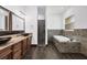 Bathroom showcasing double sinks, granite countertops, a soaking tub, and a separate shower at 431 Sevilla St, North Port, FL 34287