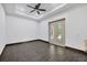 Bedroom features wood-look tile flooring, a tray ceiling, and french doors to outdoor patio at 431 Sevilla St, North Port, FL 34287
