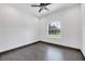 Bedroom with ceiling fan, tile floors, neutral paint, and natural light from an arched window at 431 Sevilla St, North Port, FL 34287
