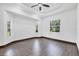 Bright bedroom with tray ceiling, ceiling fan, and natural light from the surrounding landscape at 431 Sevilla St, North Port, FL 34287