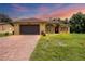 Charming single-story home featuring a brick driveway and well-maintained lawn at 431 Sevilla St, North Port, FL 34287