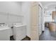 Laundry room with modern washer and dryer, and convenient access to the kitchen at 431 Sevilla St, North Port, FL 34287