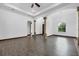Bright living room featuring elegant columns, dark trim, and large window with backyard views at 431 Sevilla St, North Port, FL 34287