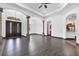 Open-concept living room with tray ceiling, elegant columns, and beautiful tile flooring at 431 Sevilla St, North Port, FL 34287