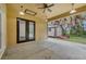 Covered patio with ceiling lights and fan, sliding glass doors, and shed in the fenced backyard at 431 Sevilla St, North Port, FL 34287