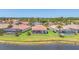 Aerial view of homes with screened lanais and well-kept lawns at 4427 Blue Heron Cir, North Port, FL 34287