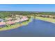 Aerial view of a waterfront community with lush landscaping and golf course at 4427 Blue Heron Cir, North Port, FL 34287