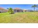 Expansive backyard featuring a screened lanai and lush lawn at 4427 Blue Heron Cir, North Port, FL 34287