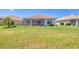 Well-maintained backyard with screened lanai and lush green lawn at 4427 Blue Heron Cir, North Port, FL 34287