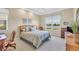 Comfortable bedroom with a large window overlooking a serene lake at 4427 Blue Heron Cir, North Port, FL 34287