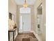 Bright and open foyer with a high ceiling, stylish rug, and elegant decor at 4427 Blue Heron Cir, North Port, FL 34287