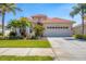 A charming home with a red tile roof, landscaped yard, and a two car garage at 4427 Blue Heron Cir, North Port, FL 34287