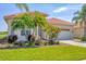 Lovely home with a well manicured lawn, red tile roof and a two car garage at 4427 Blue Heron Cir, North Port, FL 34287