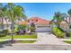 Charming home featuring a barrel tile roof, two-car garage, and a beautifully landscaped front yard at 4427 Blue Heron Cir, North Port, FL 34287