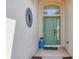 Inviting entryway featuring a pastel green front door, decorative accents, and a stylish welcome mat at 4427 Blue Heron Cir, North Port, FL 34287