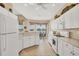 Bright kitchen with white cabinetry and scenic lake views at 4427 Blue Heron Cir, North Port, FL 34287