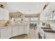 Well-lit kitchen with white cabinets and views of the lake at 4427 Blue Heron Cir, North Port, FL 34287