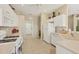 Efficient kitchen layout with white appliances and tile flooring at 4427 Blue Heron Cir, North Port, FL 34287