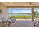 Screened-in lanai offers peaceful lake views and outdoor dining space at 4427 Blue Heron Cir, North Port, FL 34287