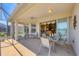Spacious lanai features outdoor dining, seating, and serene lake views at 4427 Blue Heron Cir, North Port, FL 34287