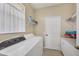 Bright laundry room with washer, dryer, storage, and natural light at 4427 Blue Heron Cir, North Port, FL 34287