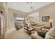 Cozy living room with comfortable sofas, view of the lake, and neutral decor at 4427 Blue Heron Cir, North Port, FL 34287