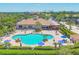 Outdoor swimming pool with palm trees, lounge chairs, and a clubhouse, perfect for relaxation at 4427 Blue Heron Cir, North Port, FL 34287