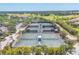 Aerial view of the community tennis courts surrounded by mature landscaping at 4427 Blue Heron Cir, North Port, FL 34287